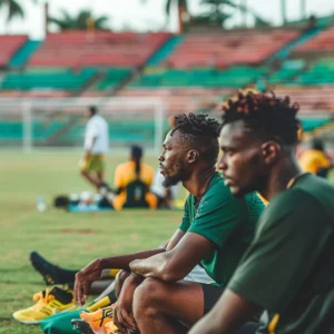 Players on the sidelines observing a cricket practice session ahead of the T20 World Cup 2024