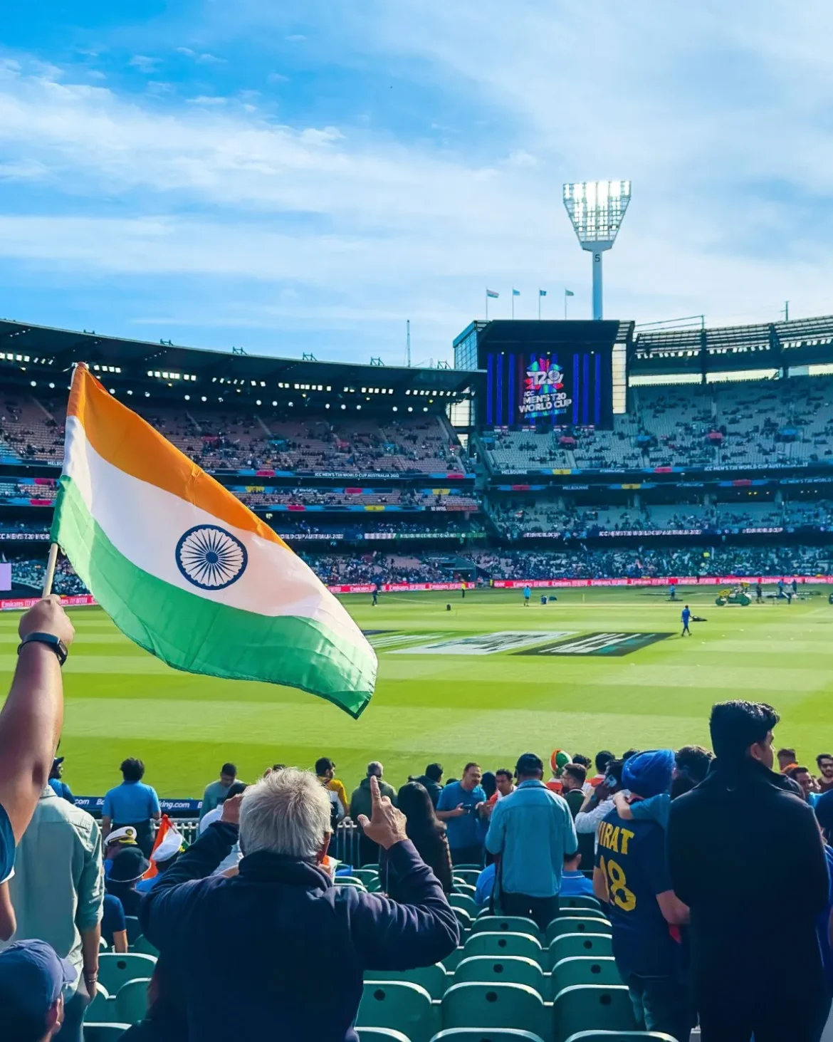 The Indian flag stands out against the backdrop of a bustling cricket stadium